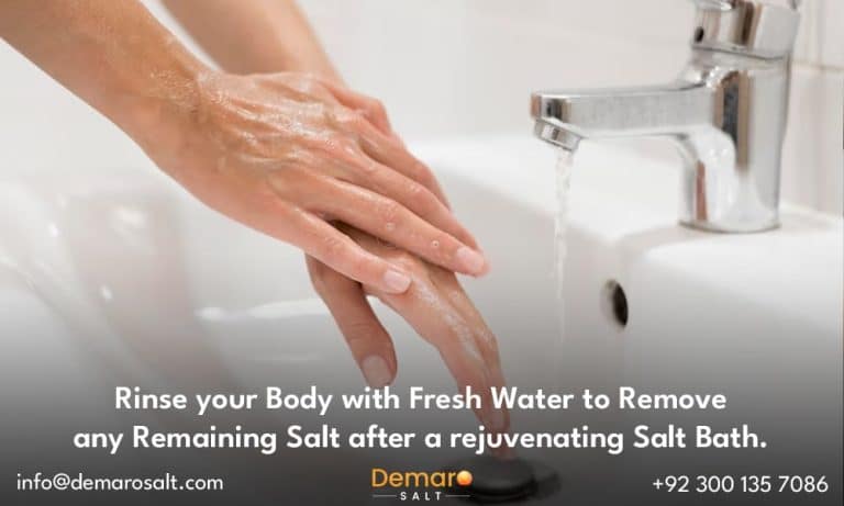A person gently rinsing off the salt residue with fresh water after a salt bath.