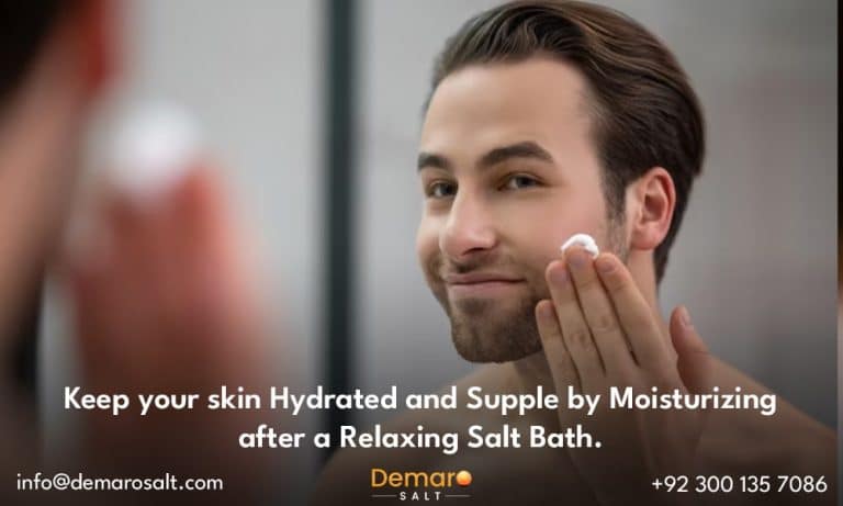 A person applying moisturizer to their skin after a salt bath.