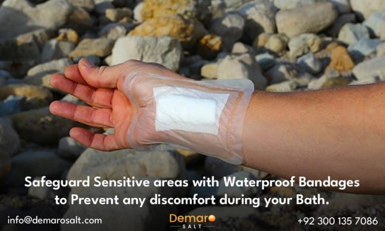 A person protecting a sensitive area with a waterproof bandage before entering the salt bath.